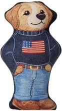 Load image into Gallery viewer, Novelty plush dog toy shaped like a smiling dog wearing a navy sweater with an American flag design, light blue cuffed jeans, a brown belt, and brown shoes.