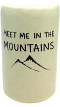 Load image into Gallery viewer, Cream ceramic tumbler featuring the phrase “Meet Me in the Mountains” in black hand-drawn lettering with a simple mountain illustration below.