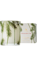Load image into Gallery viewer, Thymes Frasier Fir aromatic candle in a clear glass vessel decorated with green fir branches, shown beside its matching pineneedle-print box.