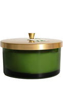 Load image into Gallery viewer, Thymes Frasier Fir candle in a deep green glass vessel with a brushed gold lid and small gold knob, shown with a product tag attached to the top.