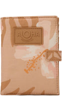 Load image into Gallery viewer, Aloha Collection passport holder in a warm tan and blush tropical floral print with a coordinating tan logo patch and tab closure.