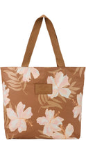 Load image into Gallery viewer, Aloha Collection tote bag in warm brown with oversized blush pink and cream hibiscus flowers, tan tropical leaves, matching brown shoulder straps, and a logo patch on the front.