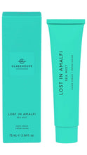 Load image into Gallery viewer, A turquoise/aqua tube of Glasshouse Fragrances 'Lost in Amalfi' Sea Mist hand cream stands next to its matching turquoise box on a plain white background.
