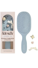 Load image into Gallery viewer, Blue paddle brush with packaging and decorative items on a white background