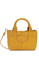 Load image into Gallery viewer, A mustard yellow leather handbag with dual top handles, a matching shoulder strap, and a central oval embossed patch, shown against a plain white background.