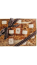 Load image into Gallery viewer, Gift set with candles and bottles of honey wrapped with a ribbon on a white background