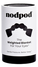 Load image into Gallery viewer, White cylindrical Nodpod packaging with a black base, featuring an image of the black weighted eye mask and text reading “The Weighted Blanket For Your Eyes” and “Gentle Pressure. Better Sleep.”
