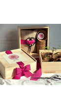 Load image into Gallery viewer, Wooden gift box with pink accents and decorative items on a white background