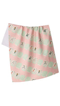 Load image into Gallery viewer, A pink kitchen towel with a repeating pattern of light green and cream mahjong tiles, shown against a plain white background.