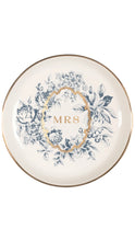 Load image into Gallery viewer, A round white ceramic plate with a blue floral wreath design, a gold oval border, and the word 'MRS' in gold at the center, finished with a thin gold rim.