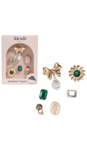 Load image into Gallery viewer, Set of gold and green charms with packaging on a white background