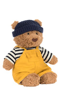 Load image into Gallery viewer, Teddy bear wearing a navy hat, striped shirt, and yellow overalls on a white background