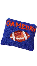 Load image into Gallery viewer, A beaded blue clutch purse featuring an orange and white beaded football design with the word 'GAMEDAY' in orange lettering across the top, set against a plain white background.