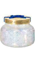 Load image into Gallery viewer, Capri Blue Artisan Volcano candle in an iridescent white glass jar with a brushed gold lid, finished with a rich blue velvet bow.