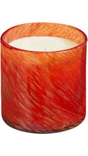 Load image into Gallery viewer, A candle in a textured glass jar with a vibrant red and orange color palette and subtle gold shimmer, set against a plain white background.