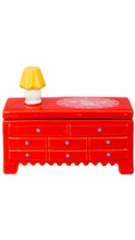 Load image into Gallery viewer, A red trinket box dresser with multiple drawers and small blue knobs, featuring a small yellow-and-white lamp on top and a white decorative pattern on the lid, isolated on a white background.