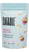 Load image into Gallery viewer, Light blue bag of Eatable Birthday Cake Pops Gourmet Popcorn featuring white chocolate popcorn with colorful sprinkles and illustrated birthday cupcakes with candles.