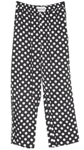 Load image into Gallery viewer, Black wide-leg trousers with a white polka dot pattern, featuring an elastic waistband and a visible KAYVIS brand label at the inner waist.