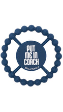 Load image into Gallery viewer, A navy blue silicone baby teether with a beaded outer ring and a central circular pad. The pad features the text 'PUT ME IN COACH' in white, with 'BELLA TUNNO' printed below it.
