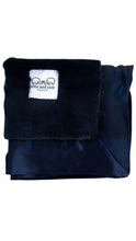 Load image into Gallery viewer, A folded dark navy blue blanket with a plush navy sherpa lining and a white brand label that reads 'ellie and sam'.