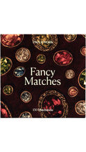 Load image into Gallery viewer, Piecework Fancy Matches box featuring a dark burgundy background decorated with jewel-like stones in rich red, green, blue, and gold tones, containing 150 matchsticks.
