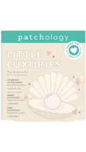 Load image into Gallery viewer, Patchology Little Luxuries Tiny Moments Kit in cream and teal packaging with a pearl shell illustration, featuring a lip treatment and two pairs of eye patches.

