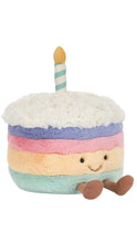 Load image into Gallery viewer, cake with rainbow stripes and a candle. The cake has a cute face and legs.
