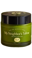 Load image into Gallery viewer, Green glass jar of My Neighbor’s Tallow Blue Moon Tallow Balm with a glossy black lid and cream-colored lettering. The 2 oz jar features simple botanical-inspired branding against a white background.
