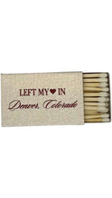 Load image into Gallery viewer, Decorative matchbox featuring the phrase “Left My Heart in Denver, Colorado” in burgundy lettering with a heart graphic, shown partially open to reveal natural wood matches with white tips.

