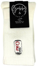 Load image into Gallery viewer, A pair of off-white ribbed knit crew socks with a small embroidered Diet Coke can patch on the front. A black paper label at the top reads 'Gabby &amp; Threads' and 'Embroidered in Nashville, TN'.
