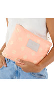 Person holding a pink pouch with gold floral pattern and 'Miu Miu' logo.