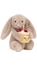 Load image into Gallery viewer, A beige bunny holding a birthday cake with strawberries and a candle on top.
