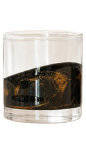 Load image into Gallery viewer, Clear whiskey glass with a black and gold marbled design wrapped around the lower half.
