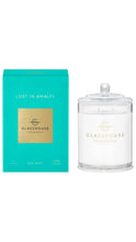 Load image into Gallery viewer, A Sea Mist scented candle by Glasshouse Fragrances next to its turquoise and gold packaging box, set against a plain white background.
