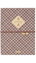 Load image into Gallery viewer, A notebook with a brown and beige gingham pattern, featuring a central cream-colored diamond label that reads 'Notebook' and a thin brown elastic closure adorned with small gold horse charms.
