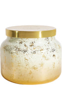Load image into Gallery viewer, Capri Blue Volcano candle in a rounded glass jar with a frosted white-to-gold ombré finish, distressed metallic gold detailing, and a polished gold lid.

