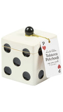 Load image into Gallery viewer, A white dice-shaped Tobacco Patchouli soy wax candle with black playing dice dots, with a gold ribbon holding a hanging white product tag on a white background.

