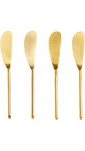 Load image into Gallery viewer, Four gold-colored metal spreaders or cheese knives with long handles and wide flat heads, arranged vertically on a plain white background.
