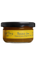 Load image into Gallery viewer, A jar of Eat This Yum! Banana Jam with a black lid and a yellow label, shown against a plain white background.
