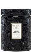 A black textured jar candle with an embossed circular pattern and a central white label reading VOLUSPA MOSO BAMBOO.