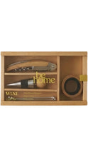 Load image into Gallery viewer, A wooden wine accessory gift set displayed in a rectangular wooden box on a white background. The set includes a corkscrew, a wine stopper, a bottle opener, and a small round accessory, with gold-colored branding and text.
