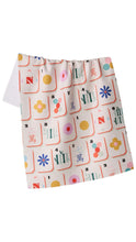 Load image into Gallery viewer, A white kitchen towel with a colorful retro mahjong tile pattern, shown hanging against a plain white background.
