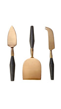 Load image into Gallery viewer, Three cheese and spread knives with brushed bronze-toned metal heads and dark charcoal handles, arranged vertically on a plain white background.
