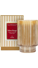 Load image into Gallery viewer, Votivo Velvet Rouge 11.2 oz candle in a ribbed gold glass vessel with coordinating striped gift box, featuring notes of cinnamon, red berries, and brown sugar.
