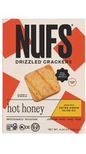 Load image into Gallery viewer, Front of a NUFs Drizzled Crackers hot honey flavor box, showing a golden-brown cracker with honey drizzle, orange geometric accents, and product text on a white background.

