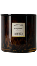 Load image into Gallery viewer, Votivo Honeysuckle 22.7 oz candle in a dark tortoise glass vessel with a black lid, featuring notes of dewy greens, honeysuckle, and floral musk.
