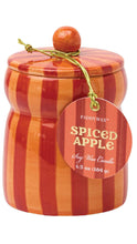 Load image into Gallery viewer, Paddywax Spiced Apple Soy Wax Candle in a decorative jar with orange and red vertical stripes, with a knob lid, and a hanging round tag.
