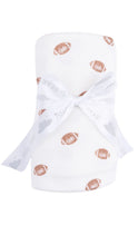 Load image into Gallery viewer, A white ribbed baby wrap or blanket with a pattern of brown tiny footballs, tied with a matching white ribbon bow.
