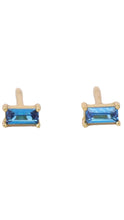Load image into Gallery viewer, A pair of gold stud earrings featuring rectangular blue gemstones in a bezel setting, shown against a plain white background.
