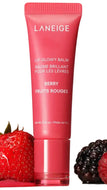 Laneige Berry Glowey Balm in a pink squeeze tube, shown with a fresh strawberry on the left and a blackberry on the right against a white background.
